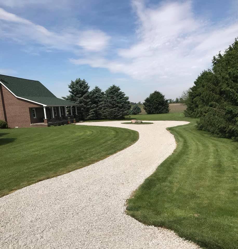 Sweeping circular gravel driveway around a country home